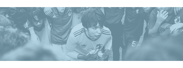 MNUFC Academy goalie pointing at MNUFC badge